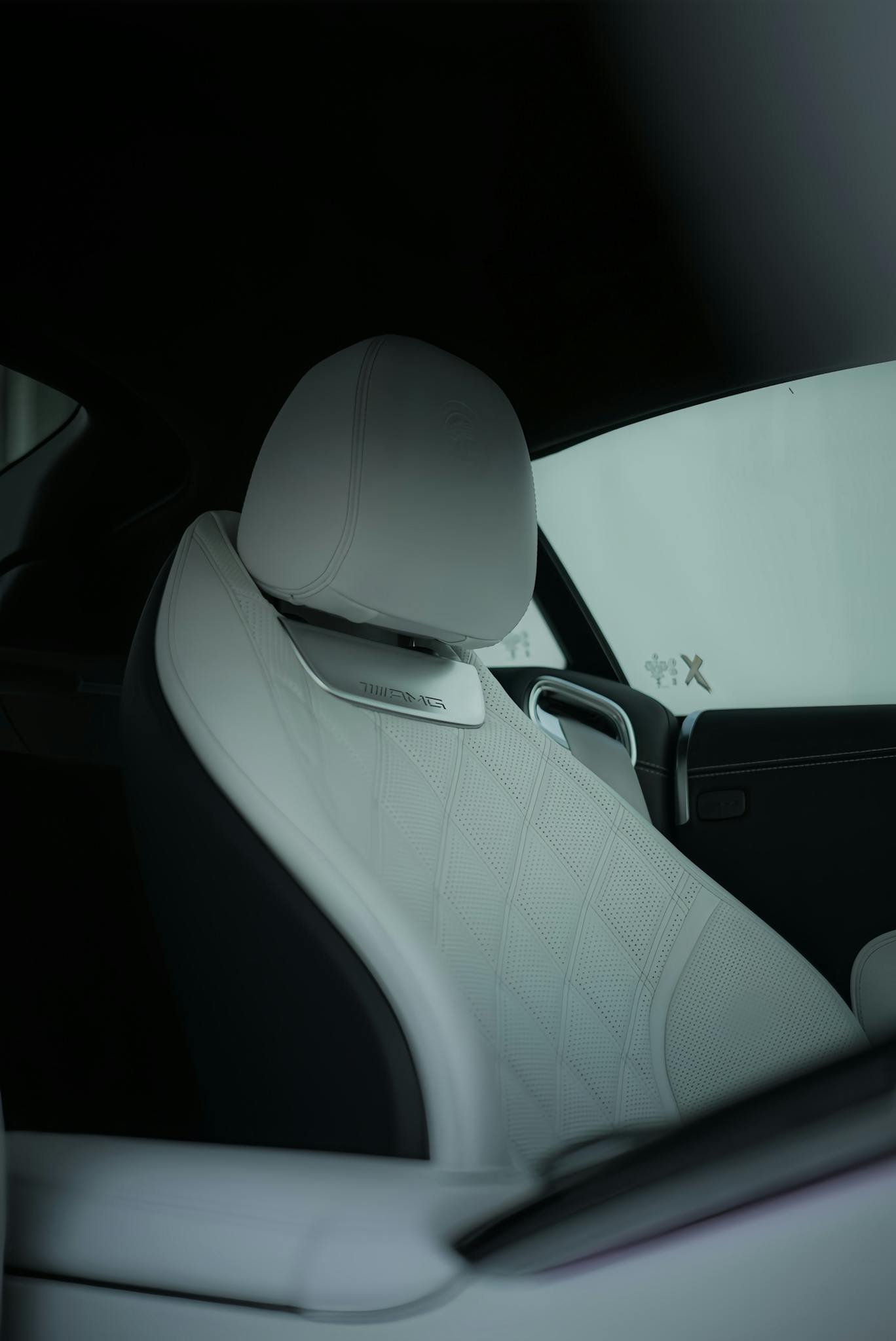 Elegant modern car interior featuring a white leather seat for luxury travel.