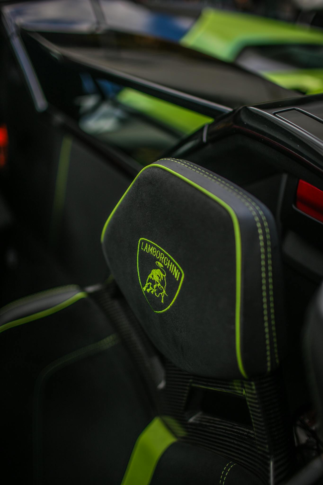 Detailed close-up of a Lamborghini car seat with brand logo and green accents.