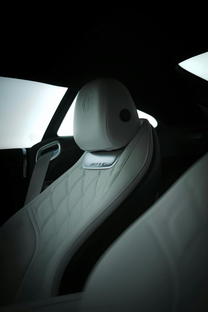 Close-up of luxury car's white leather seat showcasing premium design and detail.